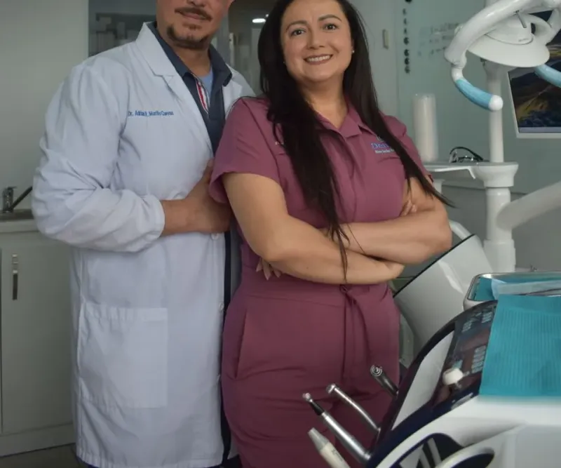 Two members of the clinic team standing in the treatment room