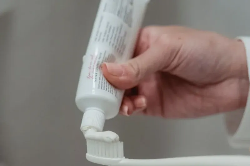 A toothbrush and toothpaste on a clean surface