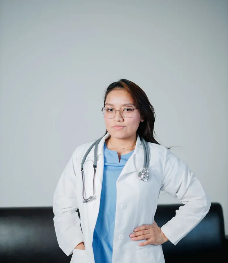 Dr. Aisyah Rahman, lead dentist, in a white coat