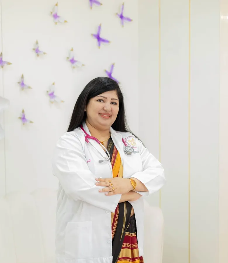 Dr. Priya Nair, dental surgeon, in a white coat