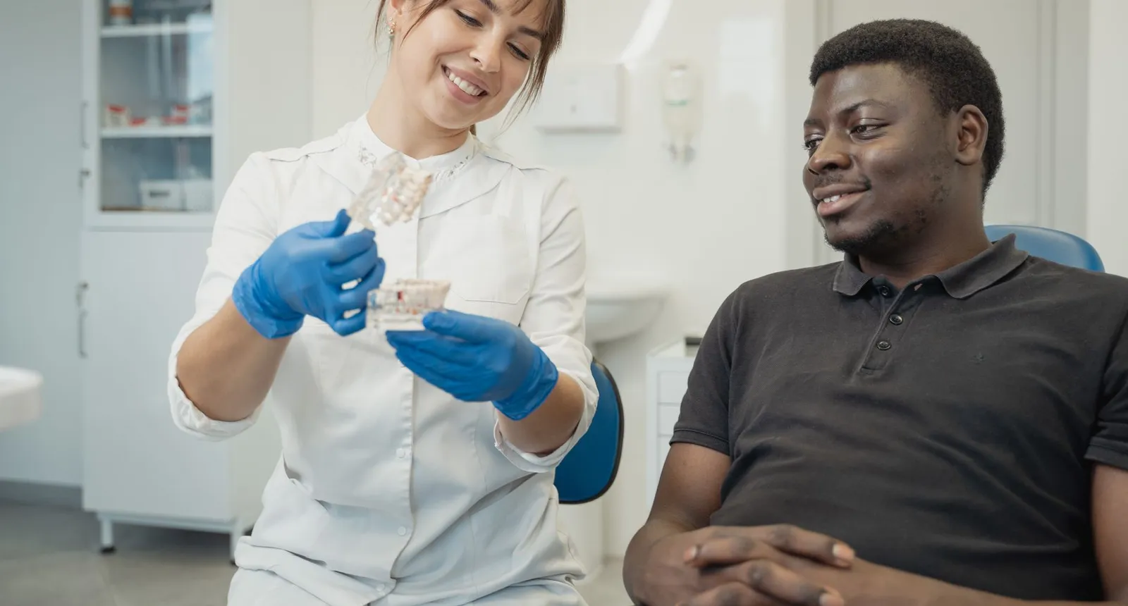 A dentist explaining a treatment to a patient